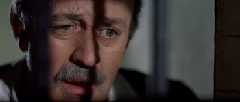 Movie still from “Exodus” (1960), directed by Otto Preminger – A man with a mustache looking at the camera; Close Up shot, High angle