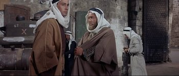 Movie still from “Exodus” (1960), directed by Otto Preminger – Two men in traditional clothing standing next to each other; Medium shot, Over the shoulder angle