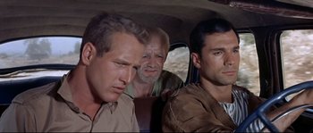 Movie still from “Exodus” (1960), directed by Otto Preminger – A group of men sitting in the back of a car; Close Up shot, High angle