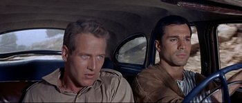 Movie still from “Exodus” (1960), directed by Otto Preminger – Two men sitting in the back seat of a car; Close Up shot, High angle