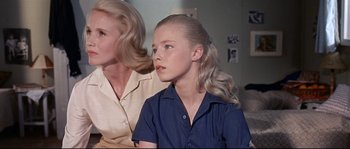 Movie still from “Exodus” (1960), directed by Otto Preminger – A woman and a young girl sitting next to each other; Close Up shot, Low angle