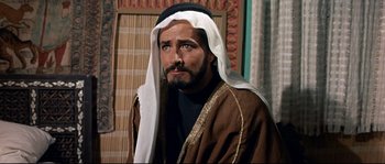 Movie still from “Exodus” (1960), directed by Otto Preminger – A man with a long beard wearing a robe and turban; Close Up shot, Over the shoulder angle
