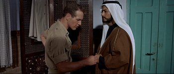Movie still from “Exodus” (1960), directed by Otto Preminger – Two men are standing next to each other; Medium shot, Over the shoulder angle
