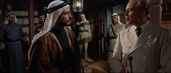 Movie still from “Exodus” (1960), directed by Otto Preminger – A group of men standing next to each other in a room; Medium shot, Over the shoulder angle