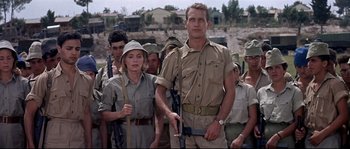 Movie still from “Exodus” (1960), directed by Otto Preminger – A group of men and women standing next to each other; Medium shot, Low angle