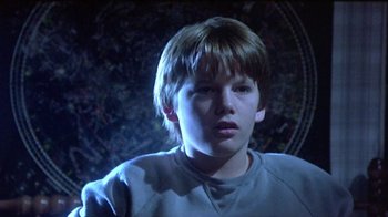 Movie still from “Explorers” (1985), directed by Joe Dante – A young boy is looking into the camera; Close Up shot, Low angle