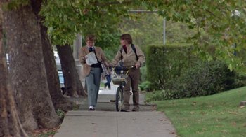 Movie still from “Explorers” (1985), directed by Joe Dante – Two women walking down a sidewalk with a bicycle; Wide shot, Low angle