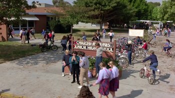 Movie still from “Explorers” (1985), directed by Joe Dante – A group of people standing outside of a building; Extreme Wide shot, High angle