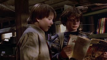 Movie still from “Explorers” (1985), directed by Joe Dante – Two young boys are reading a book together; Close Up shot, Low angle