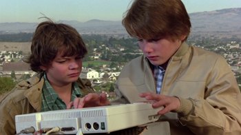 Movie still from “Explorers” (1985), directed by Joe Dante – Two young men looking at a computer screen; Close Up shot, High angle