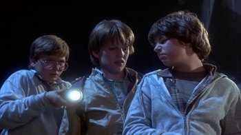 Movie still from “Explorers” (1985), directed by Joe Dante – A group of young people standing next to each other; Medium shot, Low angle