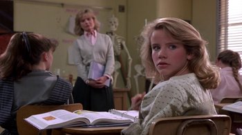 Movie still from “Explorers” (1985), directed by Joe Dante – A woman sitting at a table in front of two other women; Medium shot, Over the shoulder angle