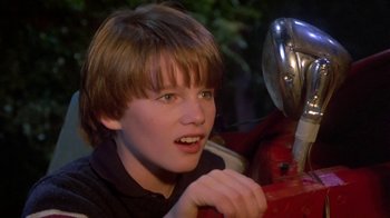Movie still from “Explorers” (1985), directed by Joe Dante – A young boy sitting in front of a fire hydrant; Close Up shot, Low angle