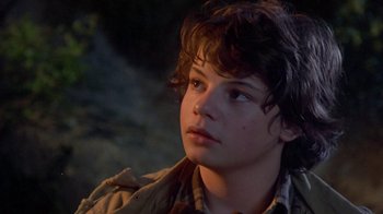 Movie still from “Explorers” (1985), directed by Joe Dante – A young boy looking up into the sky; Close Up shot, Over the shoulder angle