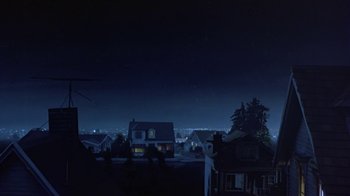 Movie still from “Explorers” (1985), directed by Joe Dante – A view of a city at night from a distance; Extreme Wide shot, Low angle