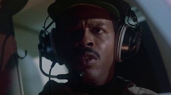 Movie still from “Explorers” (1985), directed by Joe Dante – An african american man wearing a headset and looking at the camera; Close Up shot, Low angle