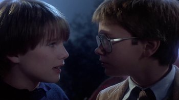 Movie still from “Explorers” (1985), directed by Joe Dante – A boy and a girl face to face in a dark room; Close Up shot, Over the shoulder angle