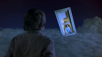 Movie still from “Explorers” (1985), directed by Joe Dante – A man standing in front of an open window; Wide shot, Low angle