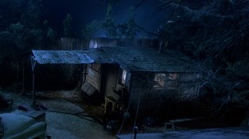 Movie still from “Explorers” (1985), directed by Joe Dante – An old house with a broken roof in the middle of the night; Extreme Wide shot, High angle