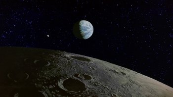 Movie still from “Explorers” (1985), directed by Joe Dante – An image of an earth and moon in the night sky; Extreme Wide shot, Low angle