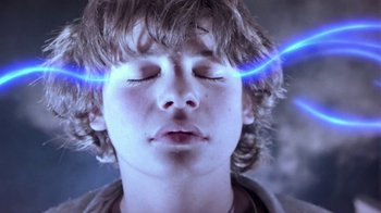 Movie still from “Explorers” (1985), directed by Joe Dante – A young man with his eyes closed with blue light coming out of his eyes; Close Up shot, Low angle