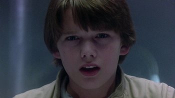 Movie still from “Explorers” (1985), directed by Joe Dante – A young boy with short brown hair and blue eyes stares at the camera; Close Up shot, Low angle