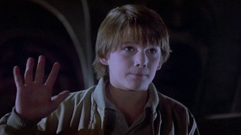 Movie still from “Explorers” (1985), directed by Joe Dante – A young man is making a peace sign; Close Up shot, Low angle