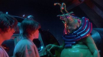 Movie still from “Explorers” (1985), directed by Joe Dante – A man and a woman are dressed up in costumes for halloween; Medium shot, Over the shoulder angle