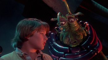 Movie still from “Explorers” (1985), directed by Joe Dante – A young boy looking at an inflatable creature; Close Up shot, Over the shoulder angle