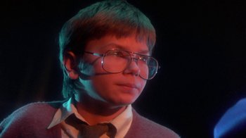 Movie still from “Explorers” (1985), directed by Joe Dante – A young man wearing glasses and a tie; Close Up shot, Low angle