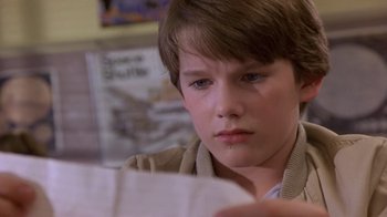 Movie still from “Explorers” (1985), directed by Joe Dante – A boy is looking at a piece of paper; Close Up shot, Over the shoulder angle