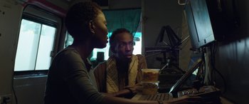 Movie still from “Eye in the Sky” (2015), directed by Gavin Hood – Two people sitting in front of a computer; Medium shot, Low angle