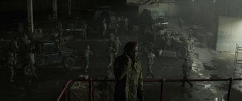 Movie still from “Eye in the Sky” (2015), directed by Gavin Hood – A man in a military uniform talking on a phone; Wide shot, High angle