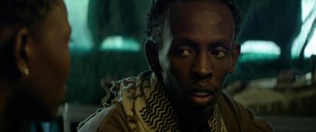 Movie still from “Eye in the Sky” (2015), directed by Gavin Hood – A person wearing a scarf; Close Up shot, Over the shoulder angle