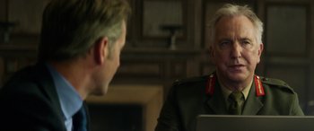 Movie still from “Eye in the Sky” (2015), directed by Gavin Hood – Two men are talking to each other in front of a computer; Close Up shot, Over the shoulder angle