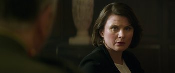 Movie still from “Eye in the Sky” (2015), directed by Gavin Hood – A person wearing a black jacket; Close Up shot, Over the shoulder angle