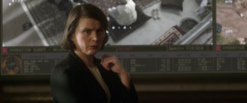 Movie still from “Eye in the Sky” (2015), directed by Gavin Hood – A woman standing in front of a projection screen; Close Up shot, Over the shoulder angle