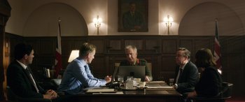 Movie still from “Eye in the Sky” (2015), directed by Gavin Hood – Two men sitting in front of a laptop computer; Medium shot, Low angle