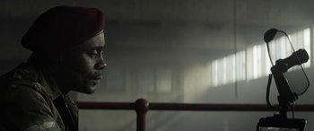 Movie still from “Eye in the Sky” (2015), directed by Gavin Hood – A person wearing a red hat; Close Up shot, Low angle