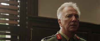 Movie still from “Eye in the Sky” (2015), directed by Gavin Hood – A person wearing a military uniform; Close Up shot, Low angle