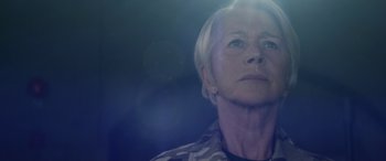 Movie still from “Eye in the Sky” (2015), directed by Gavin Hood – An older woman with short blonde hair looking up at the sky; Close Up shot, Low angle