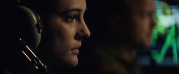 Movie still from “Eye in the Sky” (2015), directed by Gavin Hood – A woman's face in the dark; Close Up shot, Over the shoulder angle