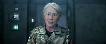 Movie still from “Eye in the Sky” (2015), directed by Gavin Hood – An older woman wearing a military uniform; Close Up shot, Low angle