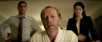 Movie still from “Eye in the Sky” (2015), directed by Gavin Hood – A person wearing a robe; Close Up shot, Over the shoulder angle