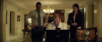 Movie still from “Eye in the Sky” (2015), directed by Gavin Hood – A man sitting in front of an open laptop computer; Medium shot, Low angle