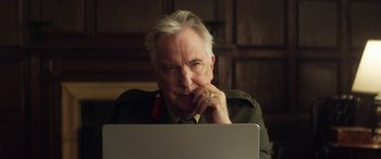 Movie still from “Eye in the Sky” (2015), directed by Gavin Hood – An older man sitting in front of a laptop computer; Close Up shot, Over the shoulder angle