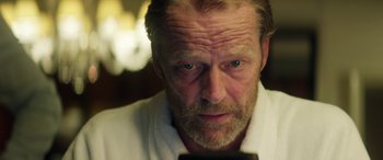 Movie still from “Eye in the Sky” (2015), directed by Gavin Hood – A person looking at a cell phone; Close Up shot, Over the shoulder angle