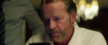 Movie still from “Eye in the Sky” (2015), directed by Gavin Hood – A person looking at a cell phone; Close Up shot, Over the shoulder angle