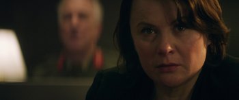 Movie still from “Eye in the Sky” (2015), directed by Gavin Hood – A person looking at the camera; Close Up shot, Over the shoulder angle