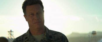 Movie still from “Eye in the Sky” (2015), directed by Gavin Hood – A person wearing a military uniform; Close Up shot, Over the shoulder angle